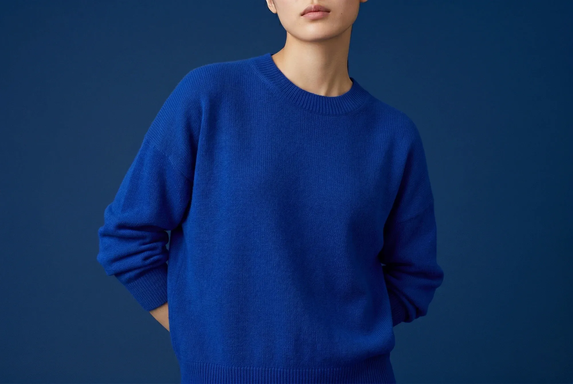 Model wearing a blue knit sweater