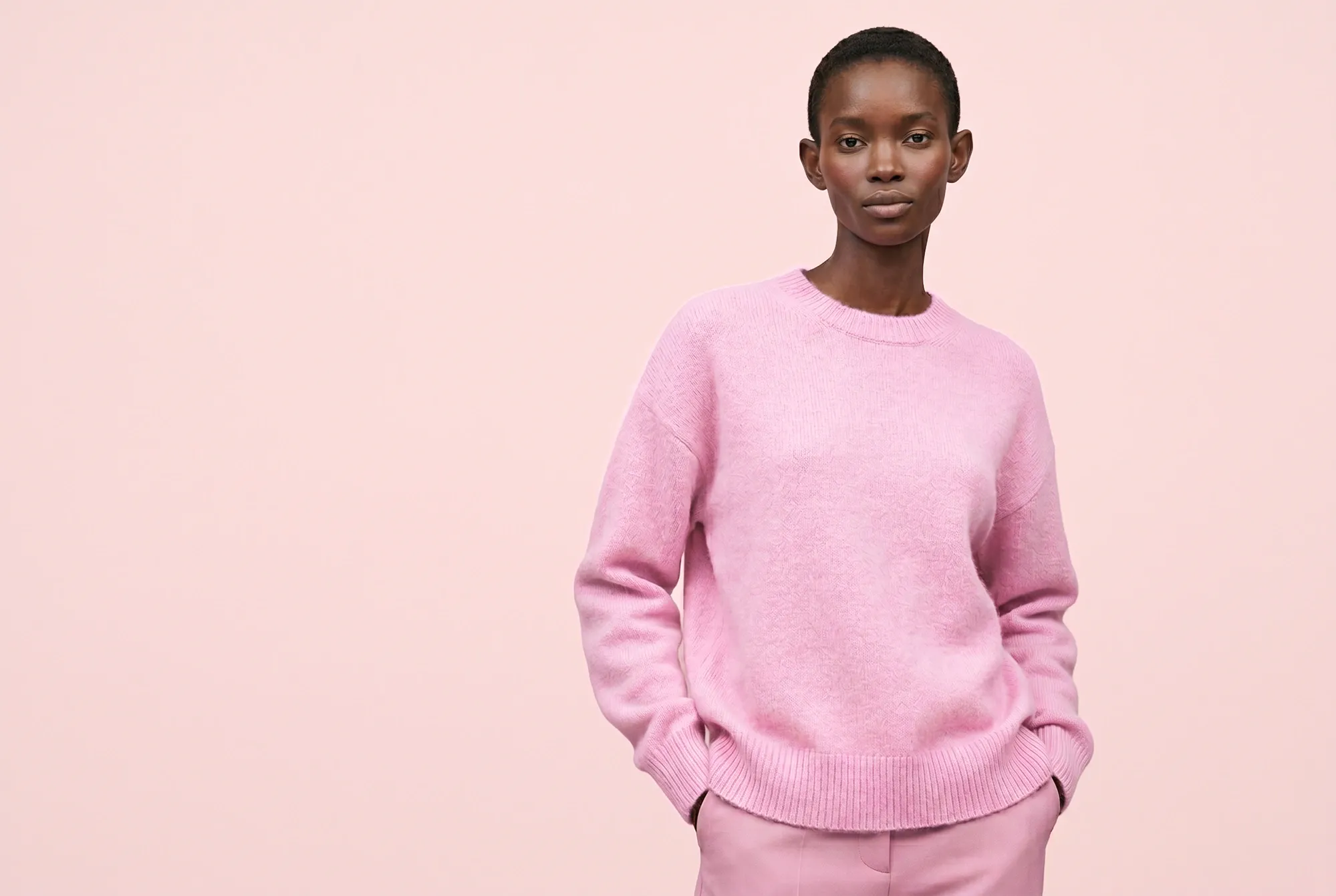 Female model wearing a colourful knit sweater